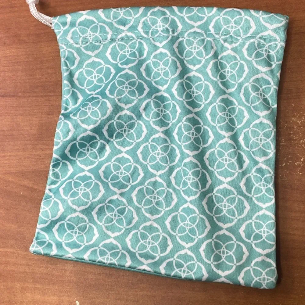 Kendra Scott jewelry bag in turquoise with white signature pattern drawstring